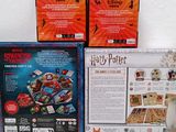 three boxes of harry potter board games sitting on a table