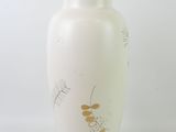 a white vase with a brown lid sitting on a white surface