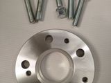 a close up of a metal plate and screws on a table