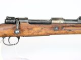 a close up of a rifle on a white surface with a white background