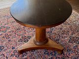 a table with a black top sitting on a rug