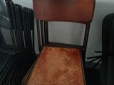 a chair that is sitting next to a stack of chairs