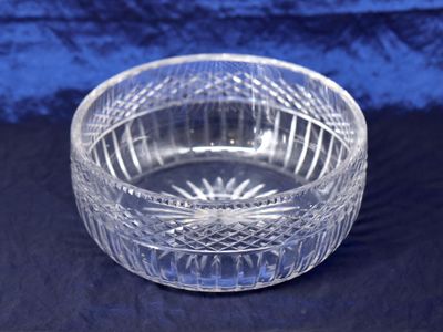 an image of a clear glass bowl sitting on a blue cloth