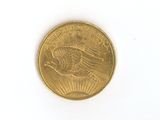 a close up of a gold coin on a white surface