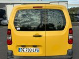 the back of a yellow van parked in a parking lot