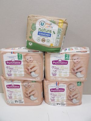 four packages of baby diapers stacked on top of each other