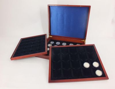 three wooden boxes with coins in them on a white surface