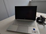 a laptop computer sitting on a table next to a window
