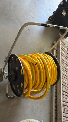 a hose and a hose reel attached to a wall