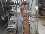 a fire extinguisor sitting in a garage next to a fire hydrant