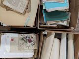 a box full of books and papers sitting on the floor