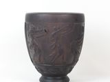 a brown bowl with a design on it