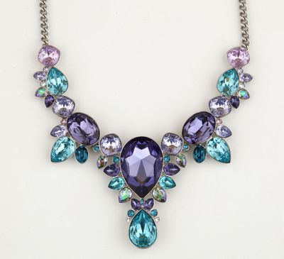 a necklace with purple and blue stones on a white background