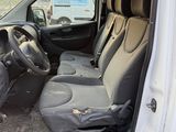 the interior of a white van with the door open