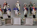 seven figurines of men in uniforms on display