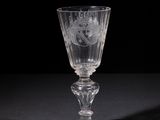 crystal goblet with a floral design on the stem of the goblet