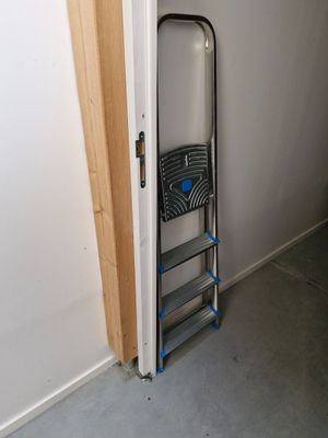 a ladder leaning against the wall next to a door