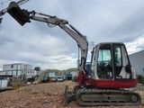 a small excavator that is sitting on the ground