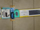 a keyboard, mouse, mouse pad, and other items on the floor