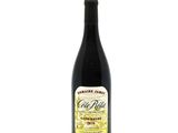 a bottle of wine sitting on top of a white table