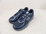 a close up of a pair of blue sneakers on a white surface