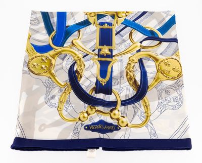 blue and white scarf with a gold buckle and a blue ribbon