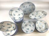 six plates and six bowls with blue flowers on them