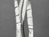 a sculpture of a man holding a knife on a pedestal