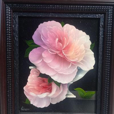 a picture of a painting of two pink flowers in a black frame