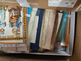 a box full of books on a table with papers