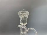 a clear glass vase with a handle and a handle