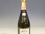 bottle of wine on a white table with a gray background