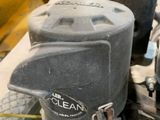 a close up of a lawn mower with a yellow handle