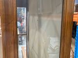 a mirror that is sitting on the floor in front of a shelf
