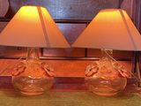 two lamps that are sitting on a table in a room