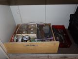 a drawer full of electronic equipment in the corner of a room