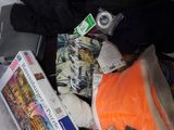 a pile of clothes and other items on a bed