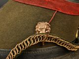 a hat with a lion head on it and a chain around it