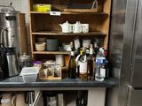 a kitchen with a stainless steel refrigerator and shelves