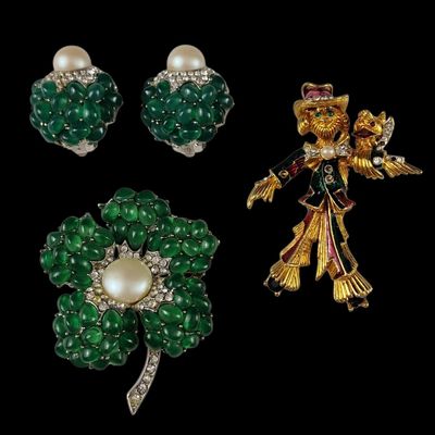 three pieces of jewelry including a broochle, earrings and a broochle