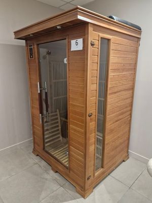a wooden saunat in the corner of a bathroom