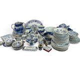 a pile of blue and white china dishes and cups