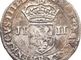 an old silver coin with a crown on top of it