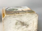 a small box with a picture on it sitting on a table