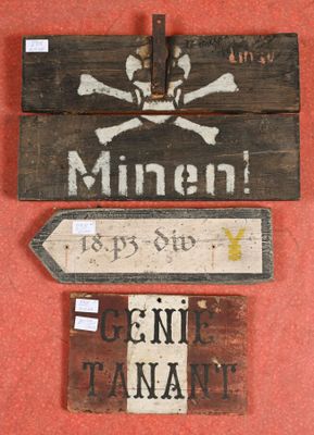 three wooden signs on the wall with a skull and crossbone on them