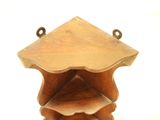 a small wooden shelf with three shelves on it