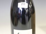 a bottle of wine sitting on a table with a label on it
