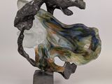 statue of a woman with a flowing dress on a marble base