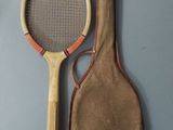 a tennis racket and a tennis ball on a table