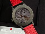 a close up of a wrist watch with a red strap